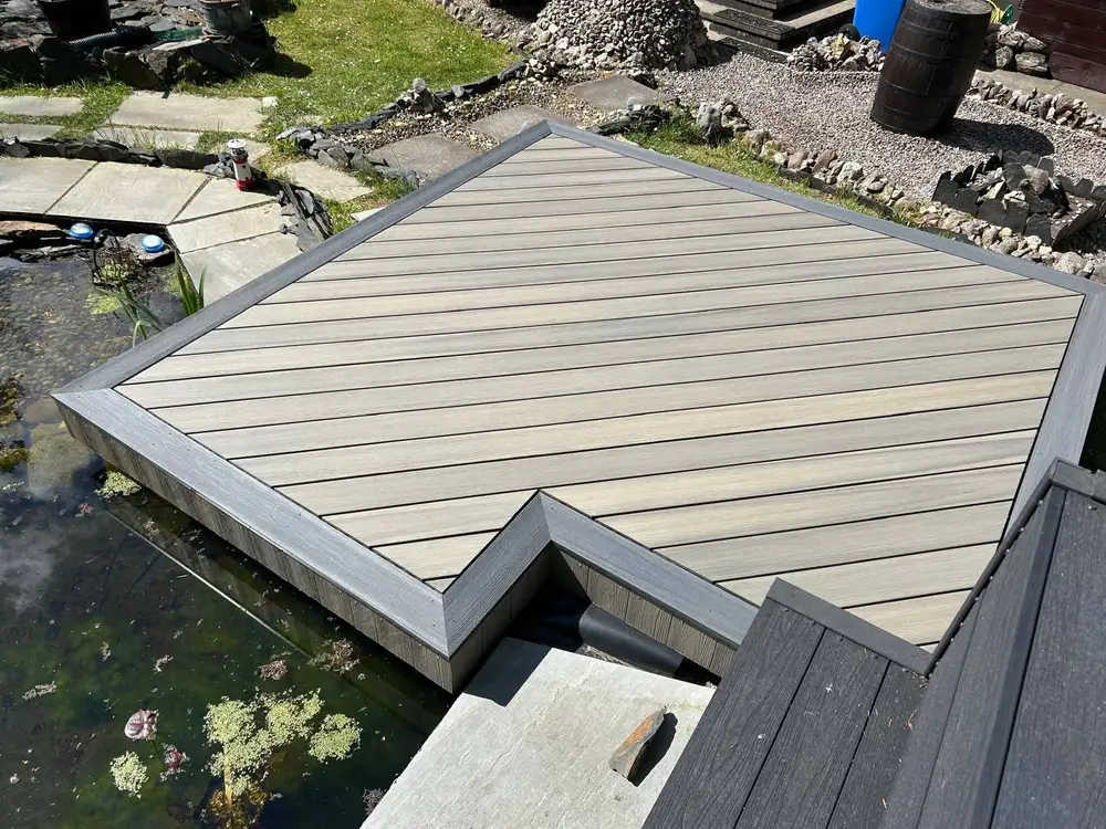 Composite decking platform built over a garden pond by Ayrshire Decking Solutions in Alloway