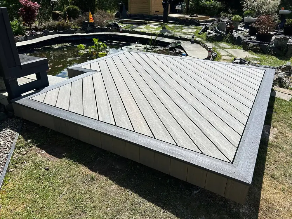 Composite decking with steps to a lower garden level installed by Ayrshire Decking Solutions in Irvine