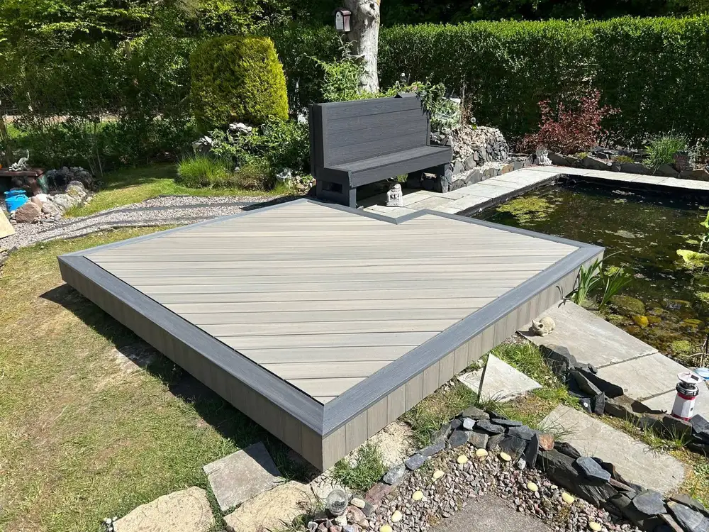Composite decking with built-in bench seating and planters installed by Ayrshire Decking Solutions in Troon
